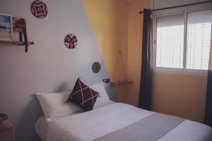 מיטה או מיטות בחדר ב-Afer Surf Hostel
