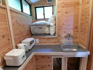 a kitchen with a sink in a wooden cabin at Shirahama Meiji Villa in Shirahama
