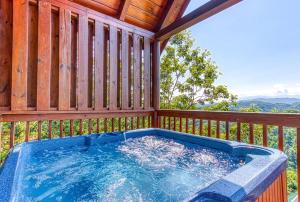 a hot tub on a deck with a wooden fence at A Higher Calling, 1089 of FREE area attraction tickets for each paid day, Dollywood and More! in Pigeon Forge