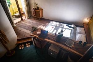 a bedroom with a bed and a wooden desk at Leranda Homestay in Hue