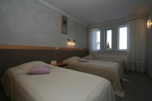 Postel nebo postele na pokoji v ubytování Hotel Sanvilla