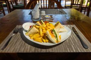 a plate of food with a sandwich and french fries at Amed Beach Resort in Amed