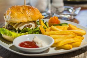 a plate of food with a sandwich and french fries at Amed Beach Resort in Amed