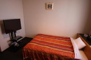 Ліжко або ліжка в номері Shingu Central Hotel