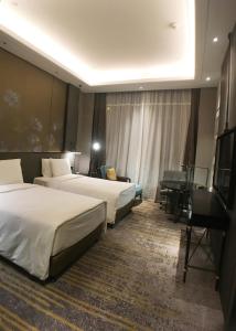 Voodi või voodid majutusasutuse Wanda Vista Changchun toas