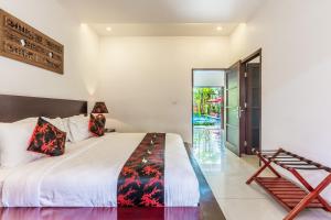 a bedroom with a large bed and a staircase at Kamar Kamar Boutique Hotel in Seminyak