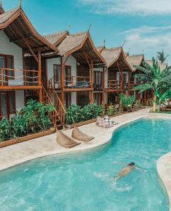 a swimming pool in front of a resort at Voodoo Gili in Gili Trawangan