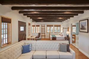 a living room with a couch and a bedroom at Zane Grey Pueblo Hotel in Avalon