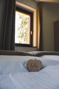 a heart shaped pillow on a white bed at Agriturismo La Casa Gialla in Romagnano