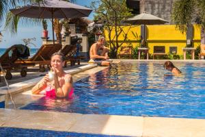 a woman in the swimming pool at a resort at Amed Beach Resort in Amed