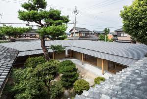 an overhead view of a house with a tree at Guesthouse Muga in Hikone