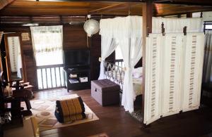 a bedroom with a bed and a television in a room at Fox Hill in Kuah
