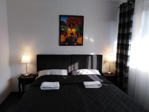 Postel nebo postele na pokoji v ubytování Filsdeger Ház - Central Rooms & Apartmans