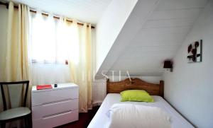 a small bedroom with a bed and a window at BDN Residence in Chamonix