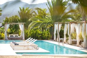 a pool with chaise lounge chairs and a resort at Can Jaume Private Villas by Ocean Drive in Ibiza Town