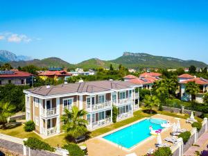 an aerial view of a large house with a swimming pool at Sweet Home Kemer Apartments in Kemer