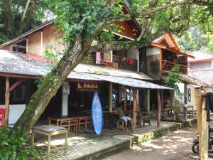 a building with a blue surfboard in front of it at BK Homestay, Batukaras in Batukaras