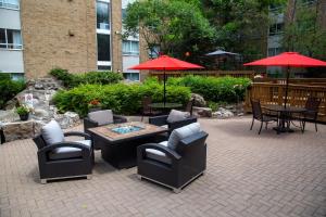a living area with chairs, tables and umbrellas at Staybridge Suites Toronto - Vaughan South, an IHG Hotel in Vaughan