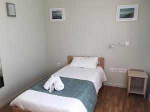 a bedroom with two beds with towels on them at Centre Jean XXIII in Annecy