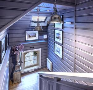 a room with blue walls and a staircase with pictures at Zajazd Plan in Wolbórz