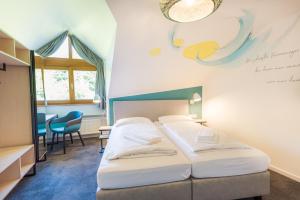 Postel nebo postele na pokoji v ubytování Hotel & Restaurant Mühlenglück