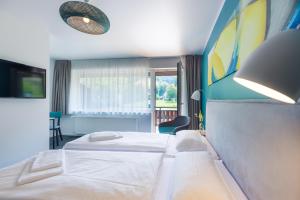 Postel nebo postele na pokoji v ubytování Hotel & Restaurant Mühlenglück