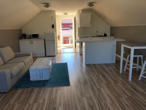 a kitchen and living room with a couch and a table at Loftet in Insjön