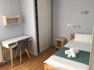 a small room with a bed and a desk at Centre Jean XXIII in Annecy