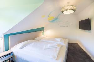 Postel nebo postele na pokoji v ubytování Hotel & Restaurant Mühlenglück