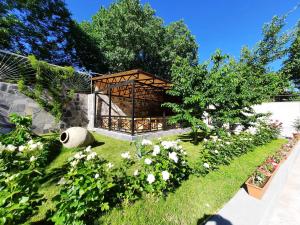 a gazebo in the middle of a garden at Cherry Garden Boutique Hotel in Yeghegnadzor
