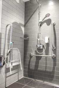 a shower stall in a bathroom with a shower head at Holiday Inn Express - London Heathrow T4, an IHG Hotel in Hillingdon