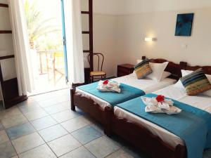 Ένα ή περισσότερα κρεβάτια σε δωμάτιο στο Hotel Boulis 