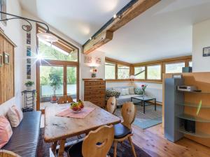 a kitchen and living room with a wooden table and chairs at Apart Linde in Hopfgarten im Brixental