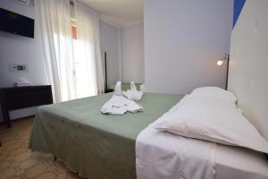 Postel nebo postele na pokoji v ubytování Hotel Como