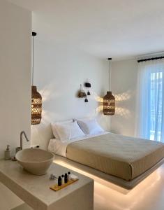 una camera con un grande letto e un lavandino di Andros Utopia a Mpatsi (Batsi)