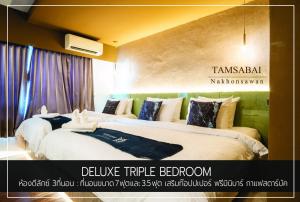 Un pat sau paturi într-o cameră la Tamsabai hotel