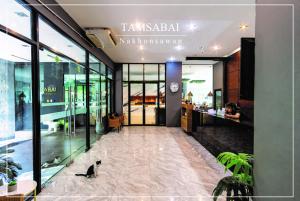 a lobby with a cat sitting in the middle of a building at Tamsabai hotel in Nakhon Sawan