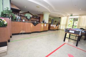 a large room with a bar and a counter at Hotel Como in Rimini