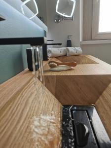 a close up of a room with a bed with wooden floors at L'Atelier du Temps - Elvimo Apartment in Aosta