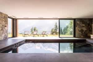 an indoor pool in a house with a view at Le Chalet Mont Blanc in Les Houches