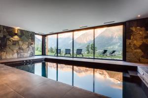 a house with a swimming pool with a mountain view at Le Chalet Mont Blanc in Les Houches