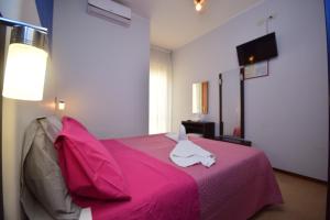 Postel nebo postele na pokoji v ubytování Hotel Como