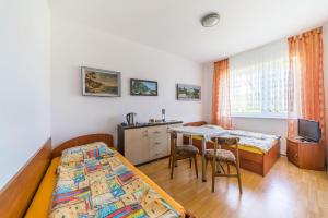 a bedroom with two beds and a desk and a table at Pokoje gościnne Neptun in Ostrowo +48 photos