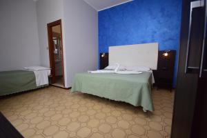 Postel nebo postele na pokoji v ubytování Hotel Como