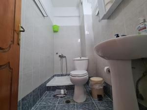 a bathroom with a toilet and a sink at Gallery in Ammouliani