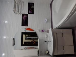 a white bathroom with a sink and a mirror at Маршала Малиновського 18 б 12 Жемчужина квартира in Odesa