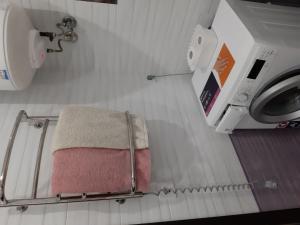 a bathroom with a towel and a washing machine at Маршала Малиновського 18 б 12 Жемчужина квартира in Odesa