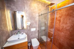 a bathroom with a shower and a sink and a toilet at Inada Hotel Ksamil in Ksamil