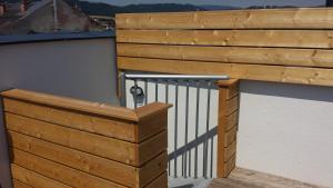 a wooden balcony with a metal railing on a building at Apartmány na náměstí in Šumperk