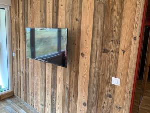 un miroir sur un mur avec une télévision sur lui dans l'établissement L'Olympic - T2 - Pied des pistes - 40 m2 - WIFI, à Val Thorens